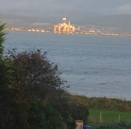 Oil rig being towed in for repair